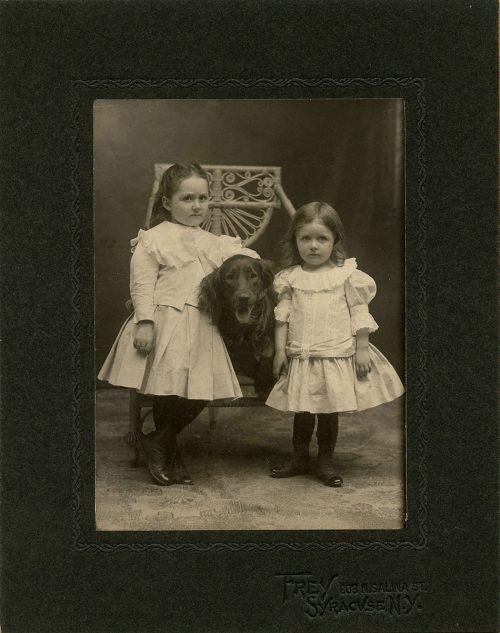 SISTERS WITH THEIR DOG.