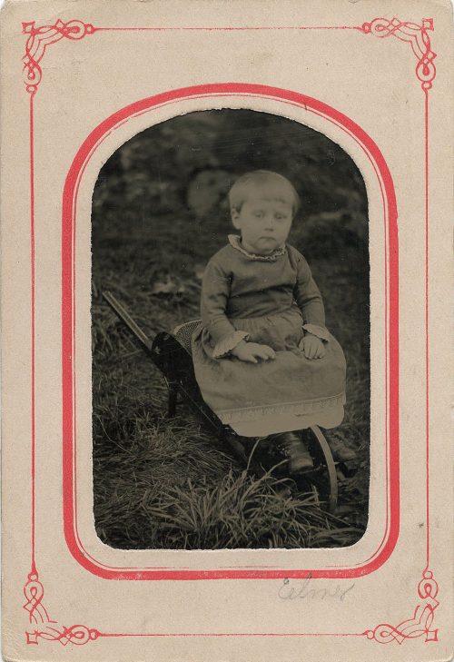 SITTING ON A WHEELBARROW