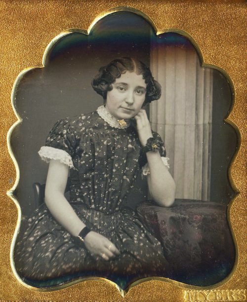 YOUNG LADY POSED WITH COLUMN.