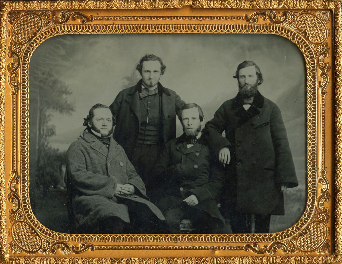 FOUR DUDES IN OVERCOATS.