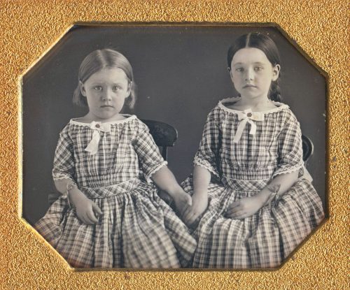 SISTERS HOLDING HANDS.